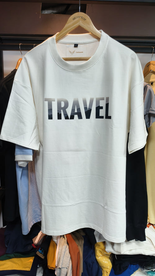 White oversized t-shirt with TRAVEL graphic print